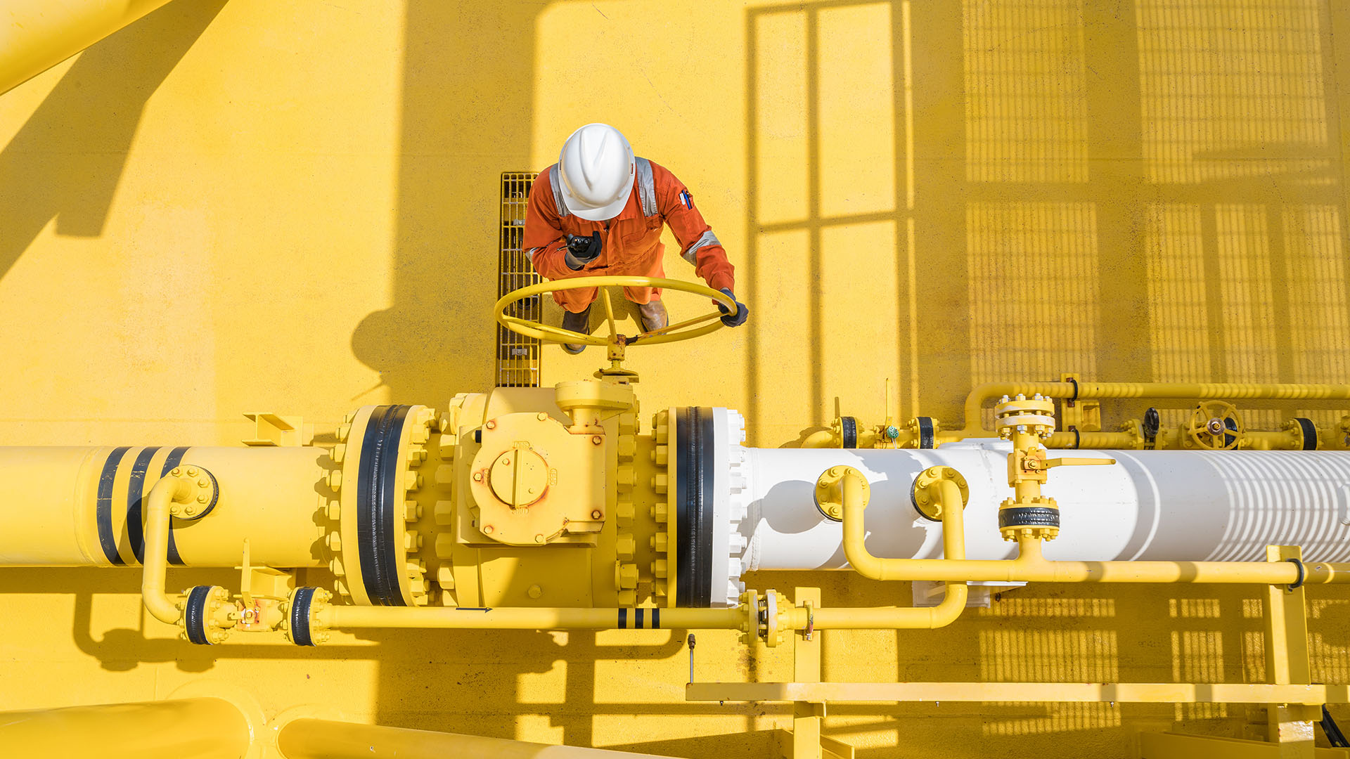 Worker turning a valve